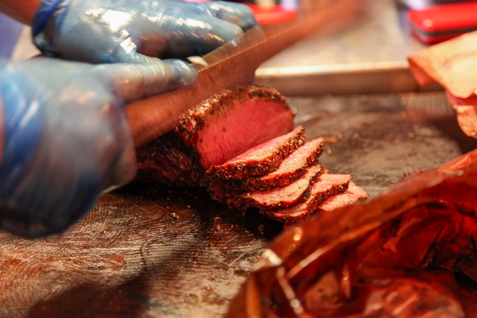 A chef slicing smoked tri-tip in the restaurant