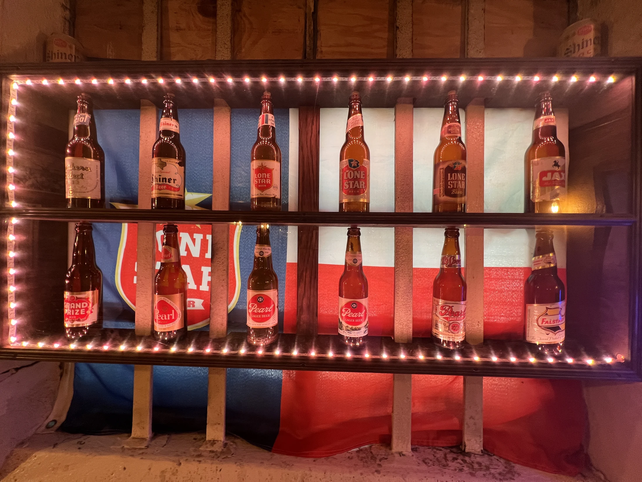 The wall-mounted Texas beer collection, including Falstaff, Pearl, Grand Prize, Shiner and Lone Star bottles